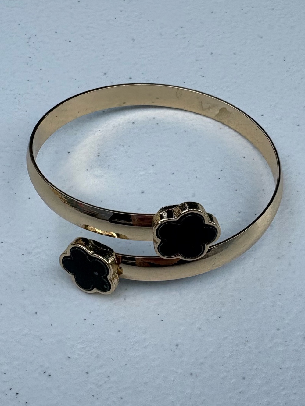 Simple gold bracelet with black flowers